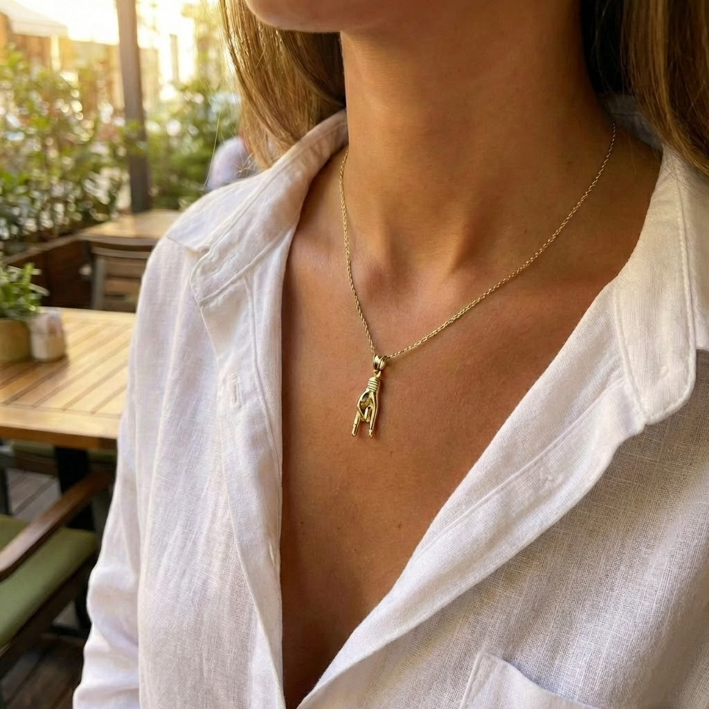 Italian Mano Cornuto hand pendant 10k gold good luck amulet charm worn by female model 
