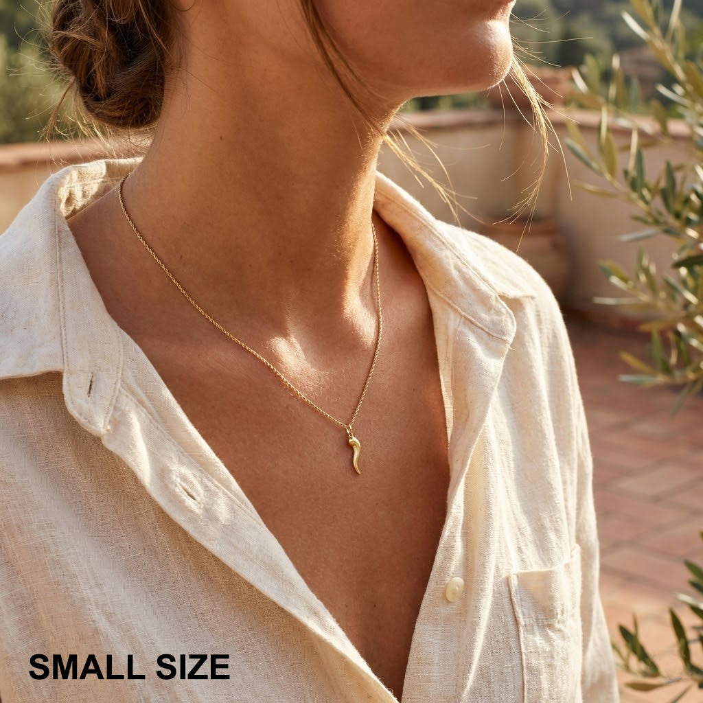 Woman wearing a gold italian horn necklace 