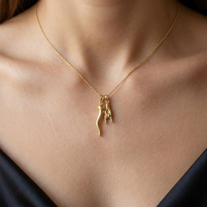 women wearing gold italian horn and hand necklace 