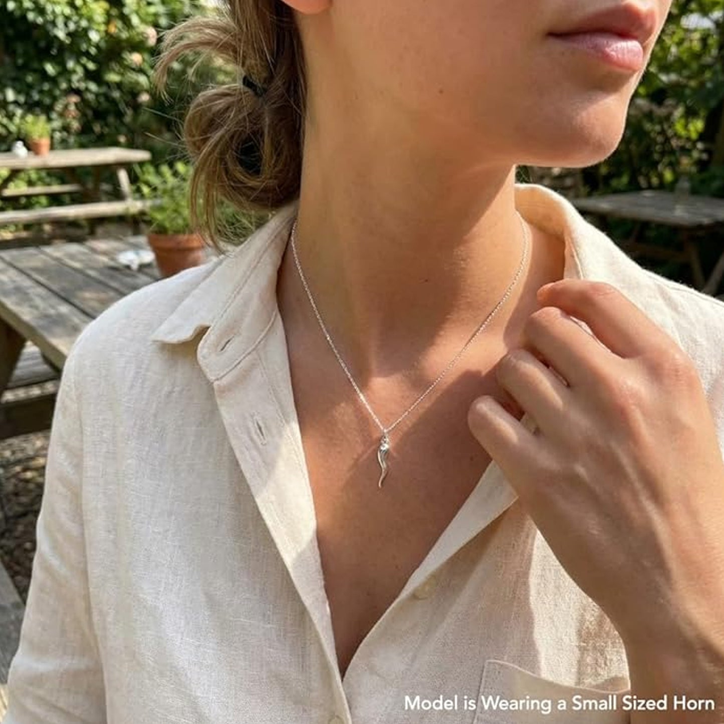 Female model wearing a silver italian horn necklace 