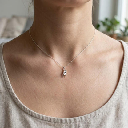 female model wearing silver italian mano hand necklace
